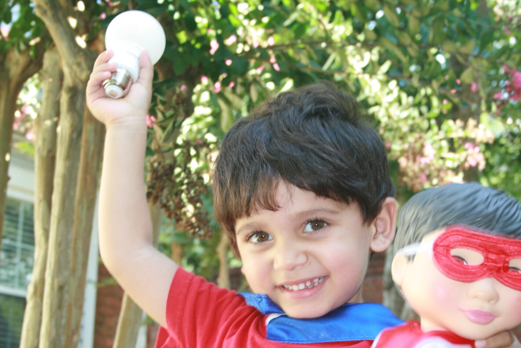 Young boy holding an energy efficient lightbulb
