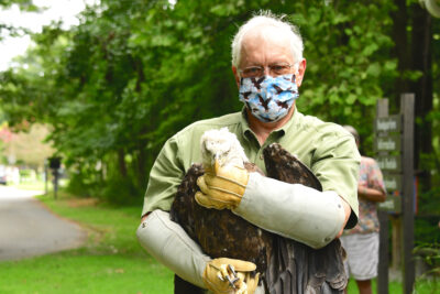 Man holding a bald eagle.
