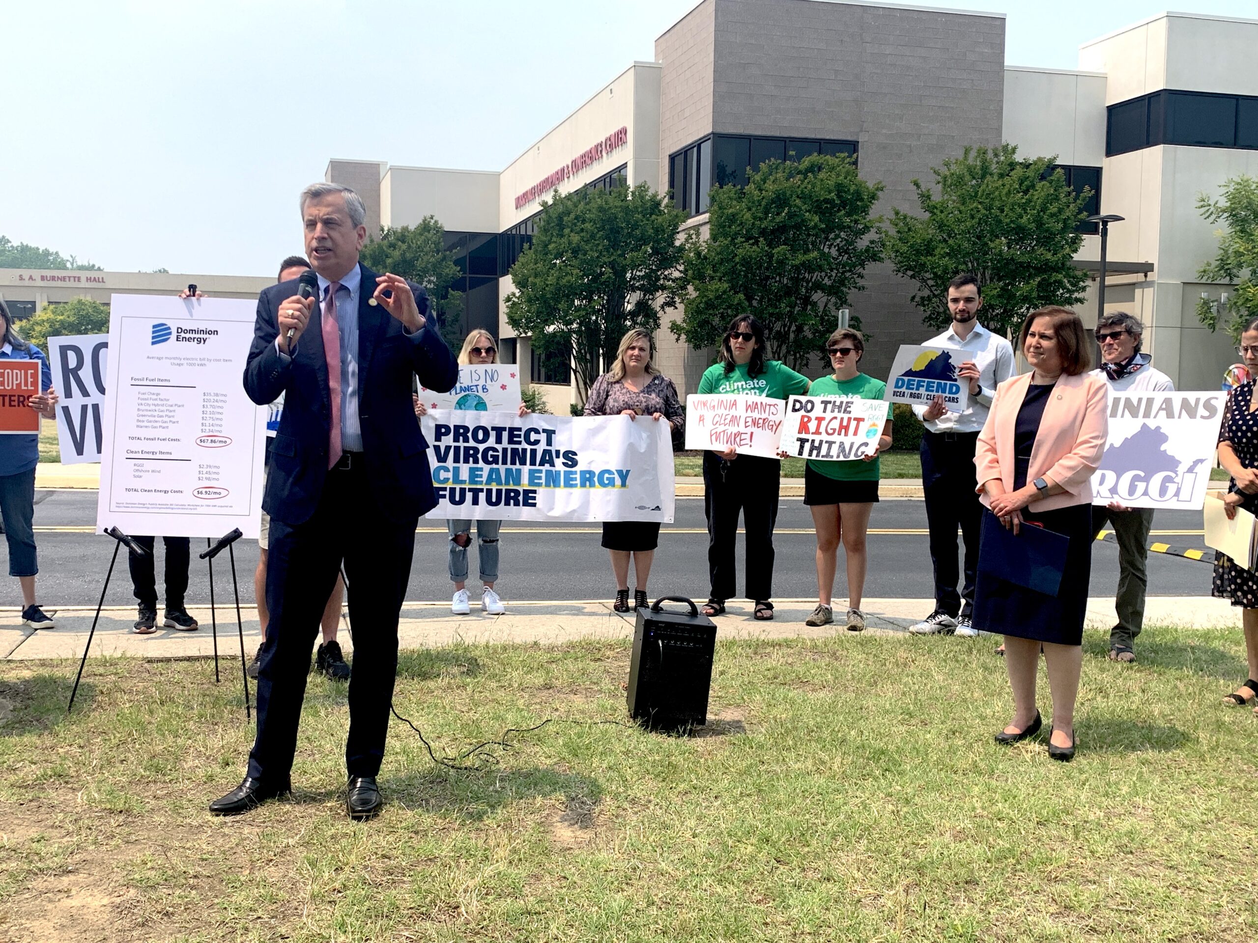 Virginia legislators including Del Sullivan (left) and Sen Hashmi (right) defend Virginia's participation in RGGI outside of the Air Pollution Board's meeting.