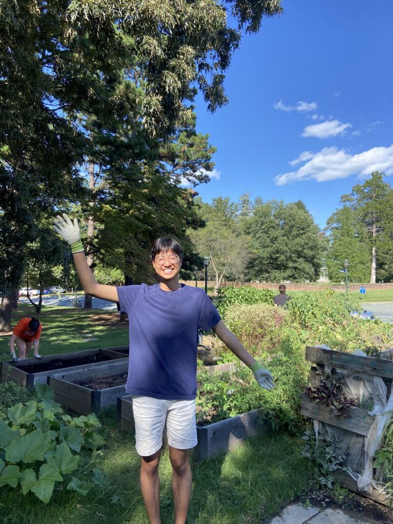 Tytus waving to the camera while outside gardening
