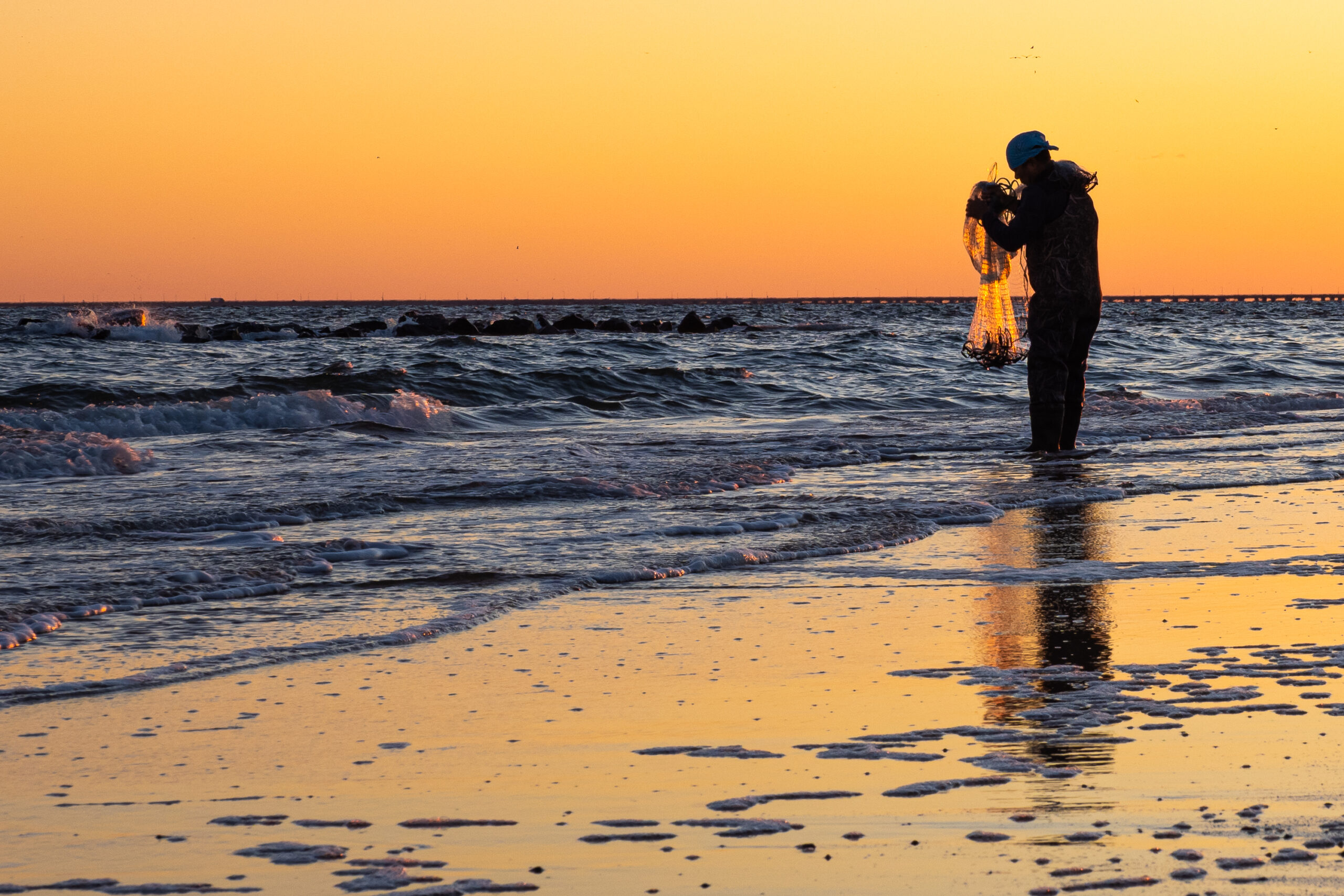 Cast Net Fisherman enjoying the early sun on East Ocean View Beach