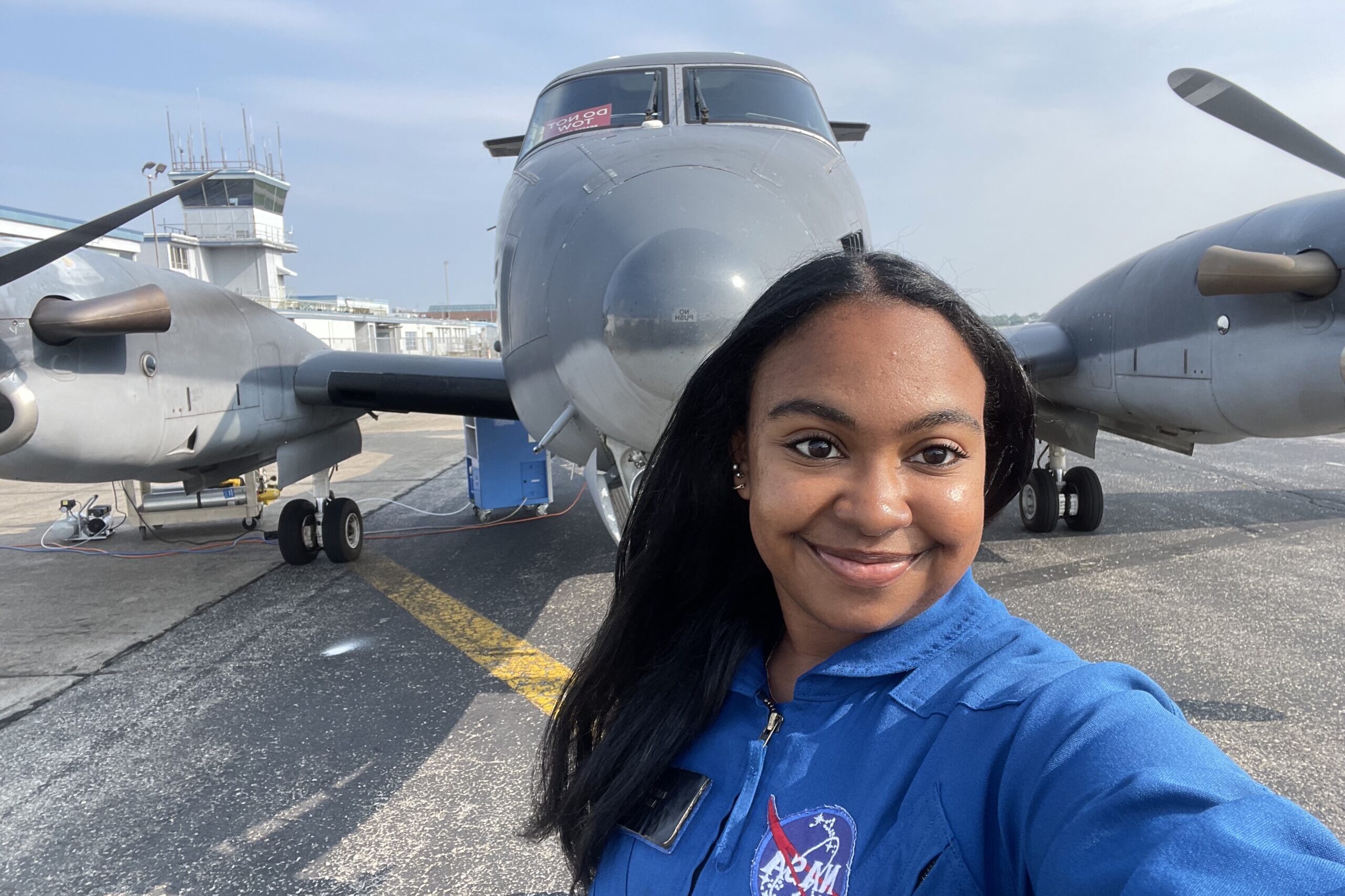 Victoria Jenkins taking a selfie in front of an airplane