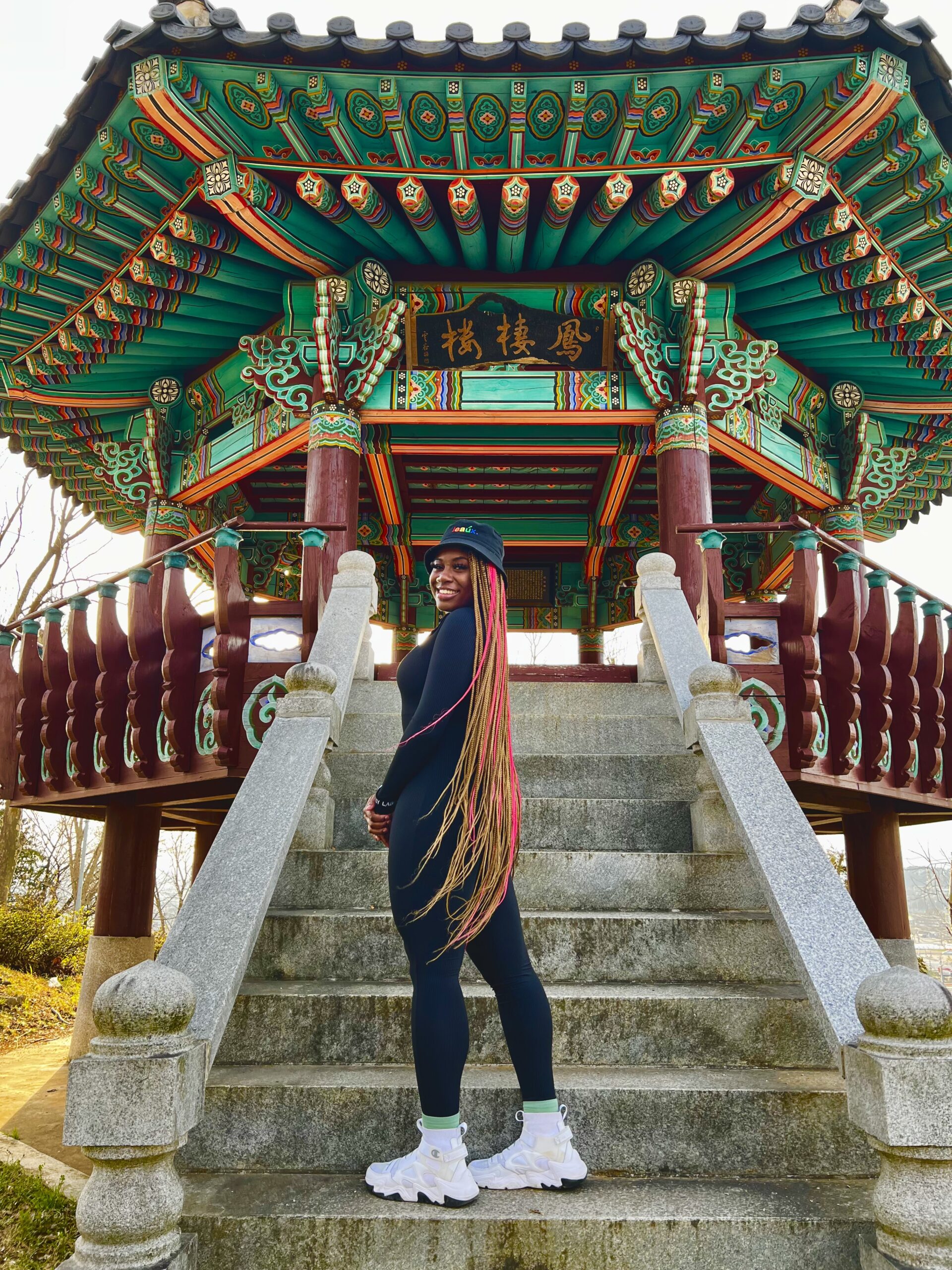 Anjel Iriaghomo standing on the steps of a temple in Gwangju, South Korea